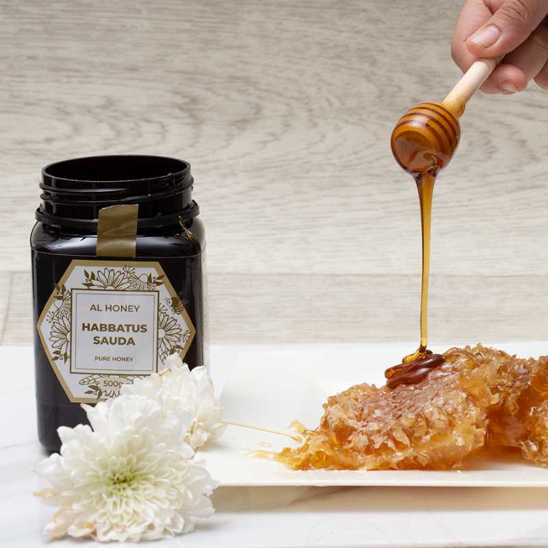 Photo of al Honey blackseed honey drizzling on honey comb. Sign of purity