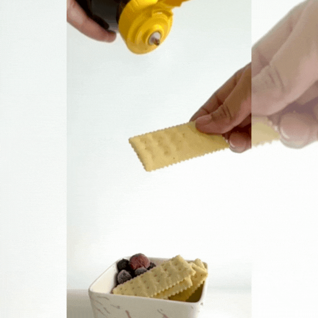 Front view Al honey premium sidr squeezing honey on biscuits and fruits
