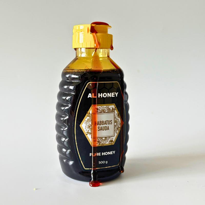 Front view of l Honey blackseed honey with honey dripping