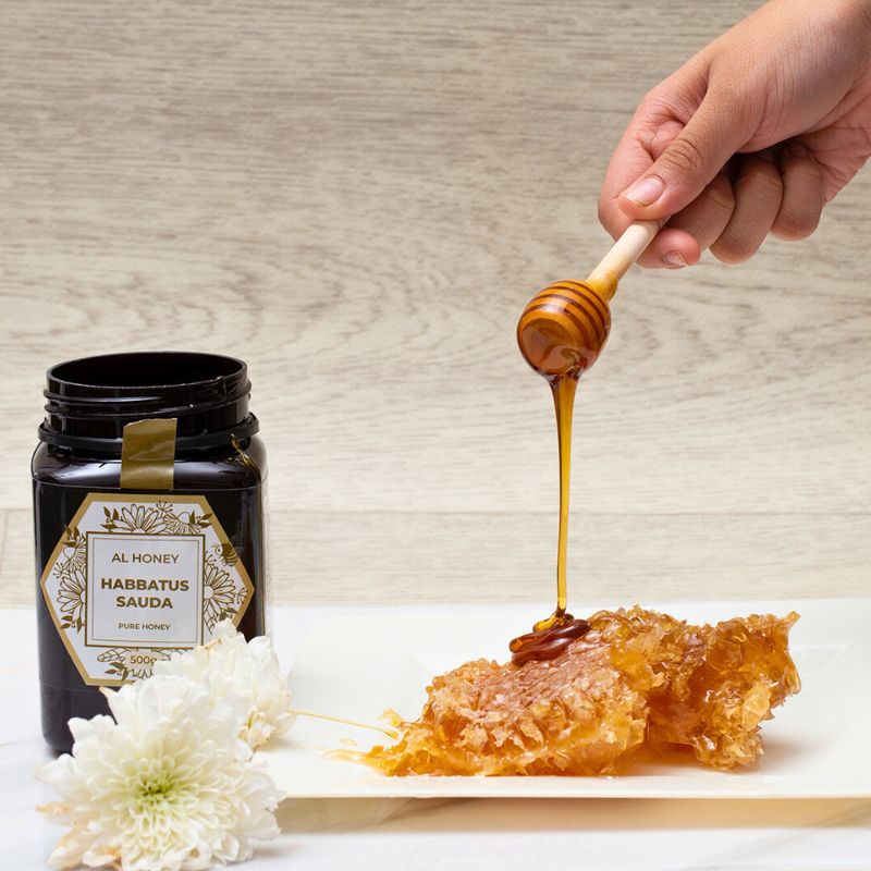 Al Honey's delicious HabatulSauda Honey. Showing the Purity of Honey and honey dip on a honeycomb.