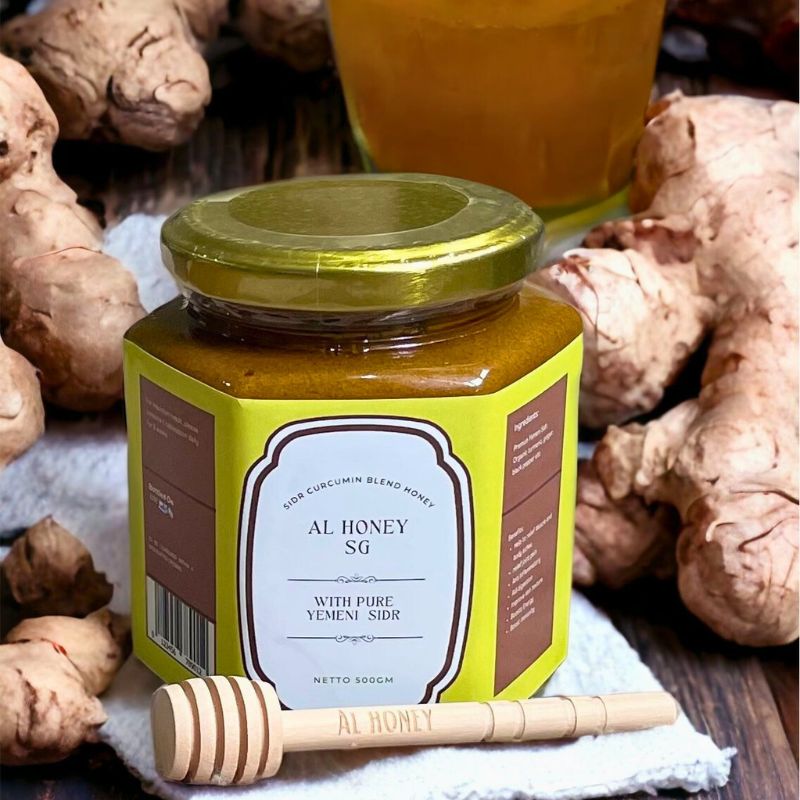 Al Honey's delicious Sidr curcumin blend. Showing the product and glass bottle along with wooden stick.