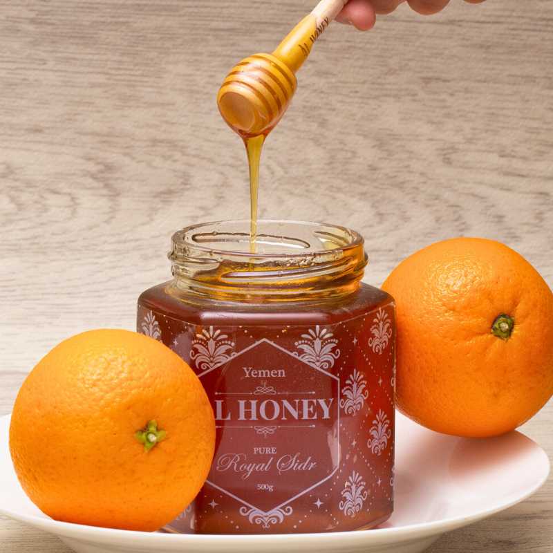Drizzling Royal Sidr honey and showing oranges a sign of purity and deliciousness 