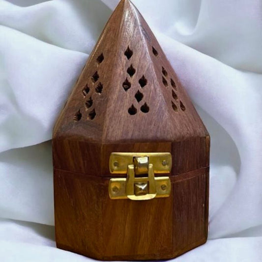 Showing a closed woody Oasis wooden hex pyramid shaped burner for bukhoor, oud and agarwood placed on white textile